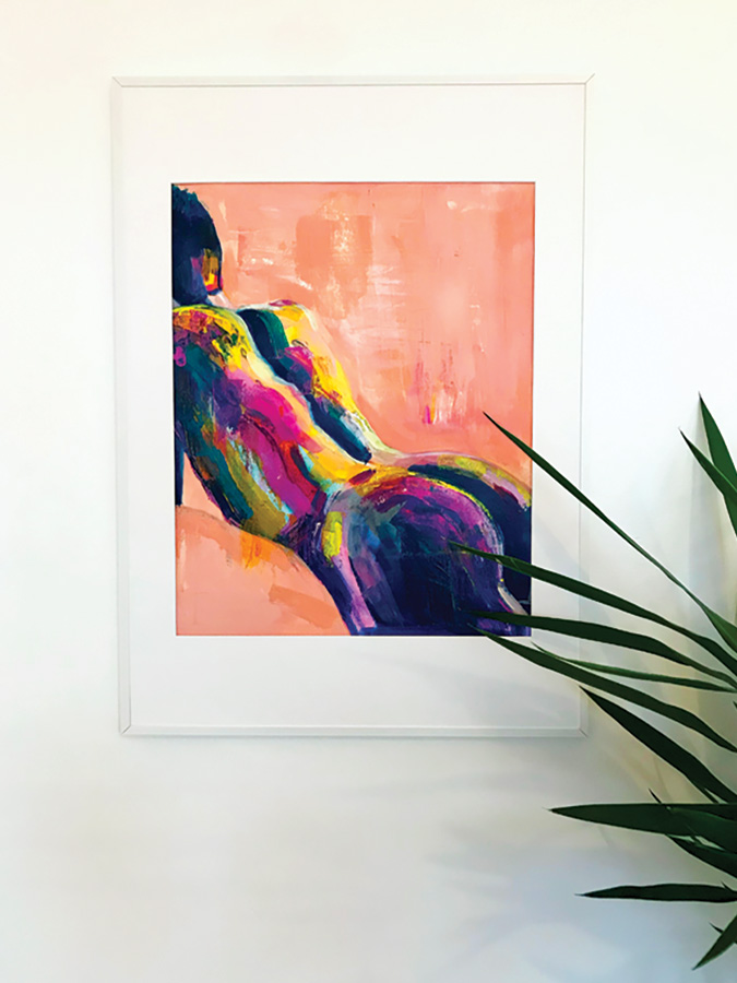 colourfully painted man leaning on a peach background