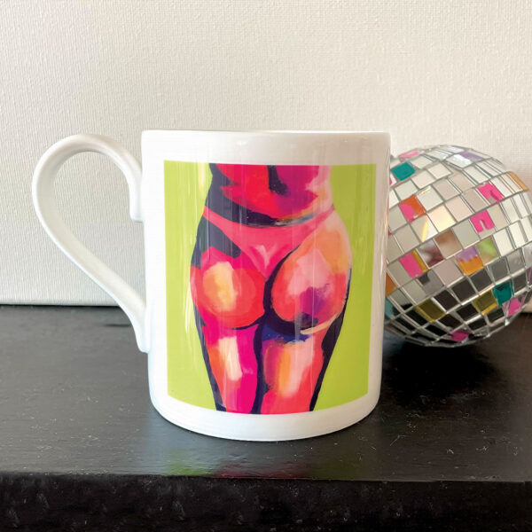 Lime green china mug with bum painting and disco ball to side